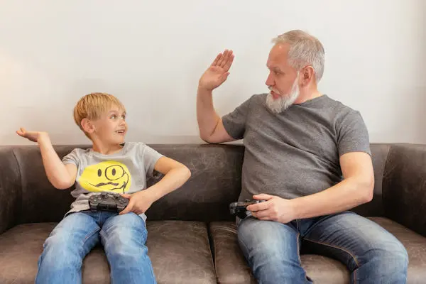 kid and grandfather high 5