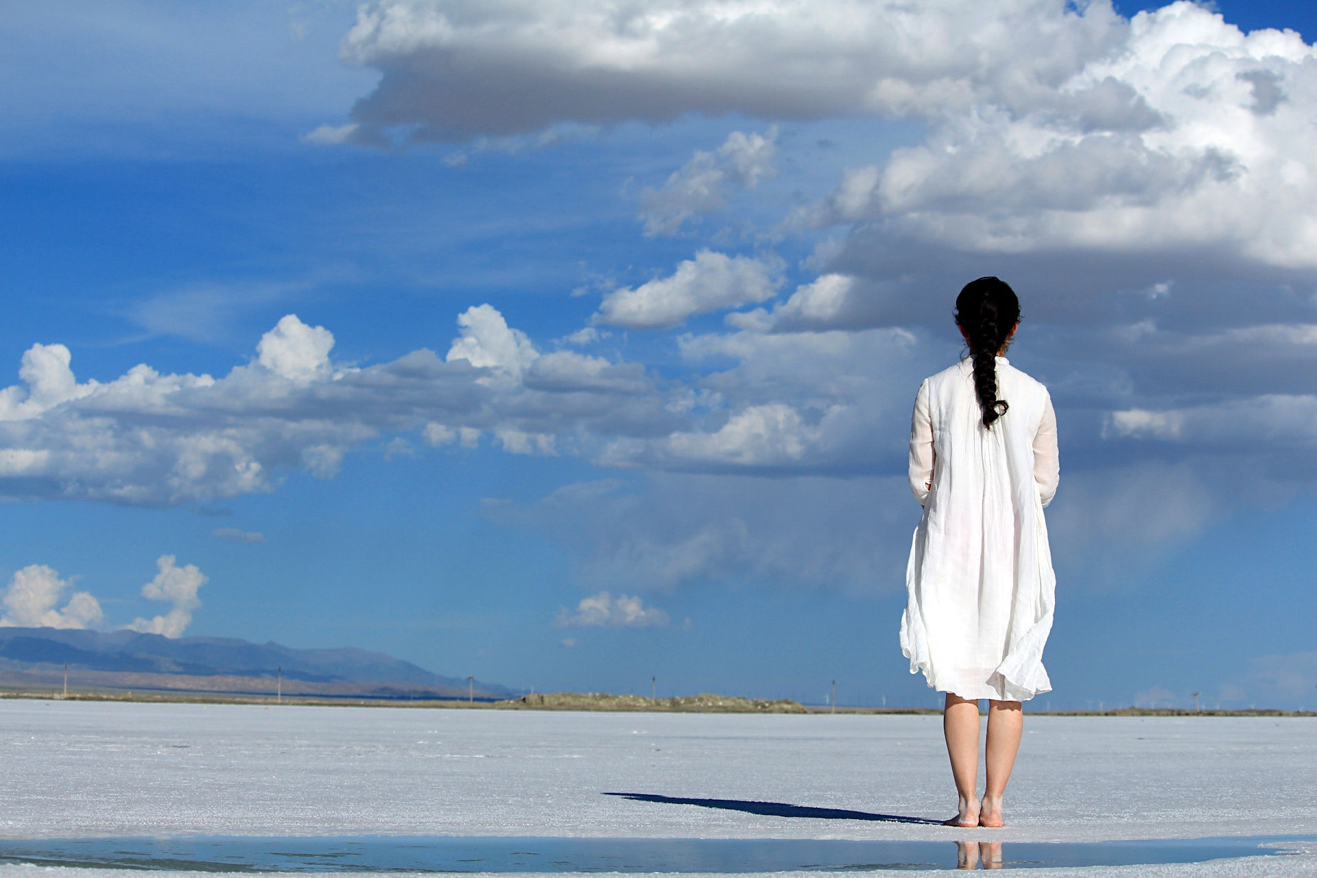 Woman under blue skies on beach